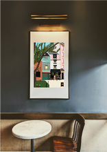 Load image into Gallery viewer, Printed illustration of French market in pastel colours, framed with borders in coffee shop
